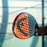 person holding orange and white polka dot round ball