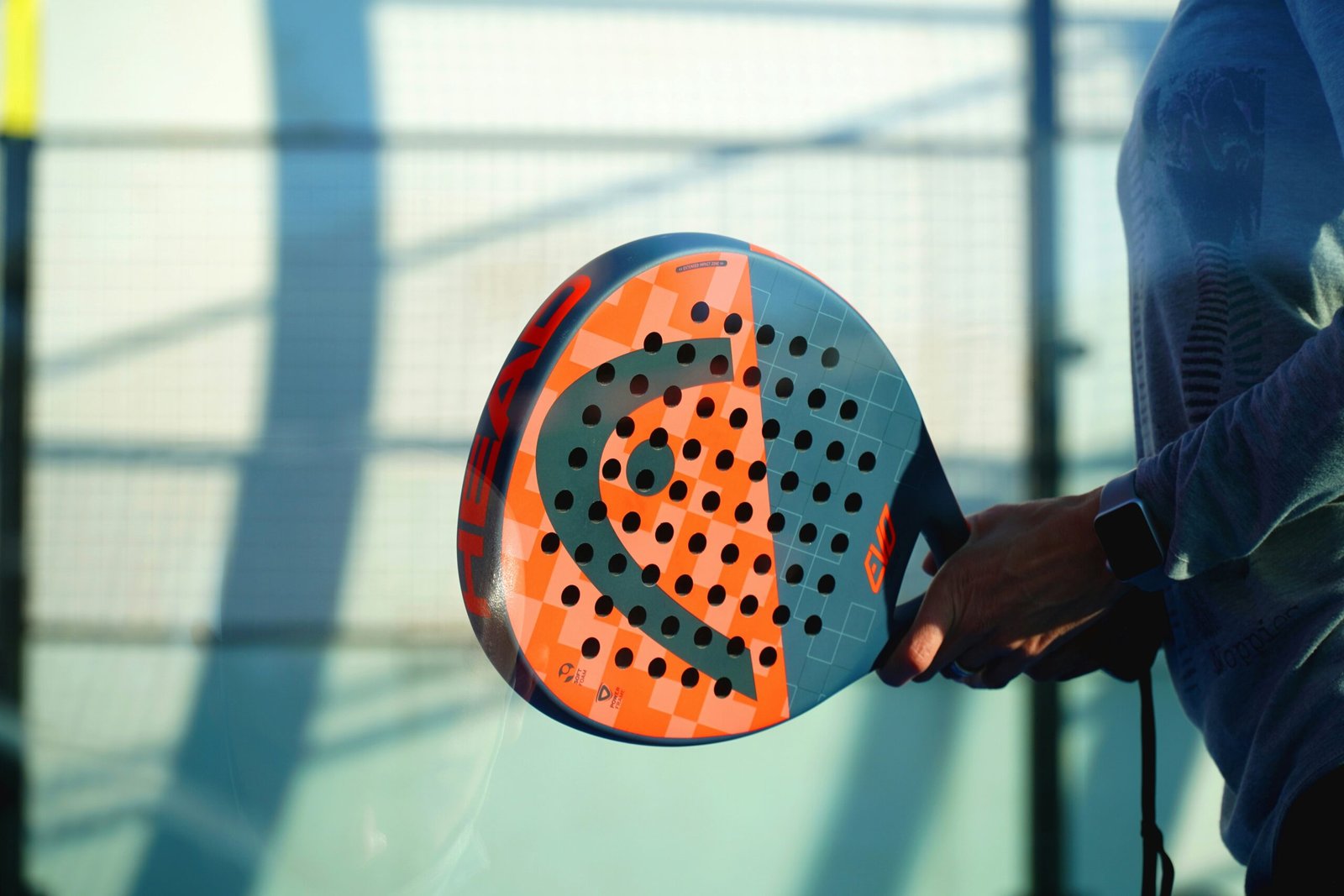 person holding orange and white polka dot round ball